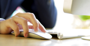 A person interacting with a computer via a mouse