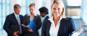 Cute business woman with colleagues in discussion at the background