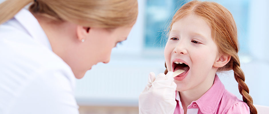 child having her tonsils inspected