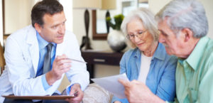 A doctor going over the finer points of a diagnosis with a senior couple